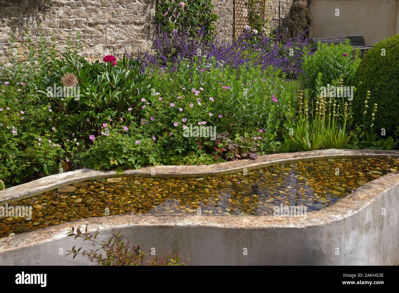 Raised shallow pond water feature in english garden Stock Photo