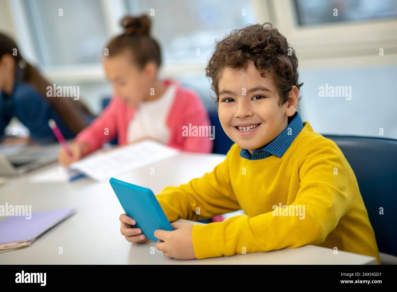 Pupil being happy using modern devices at school Stock Photo