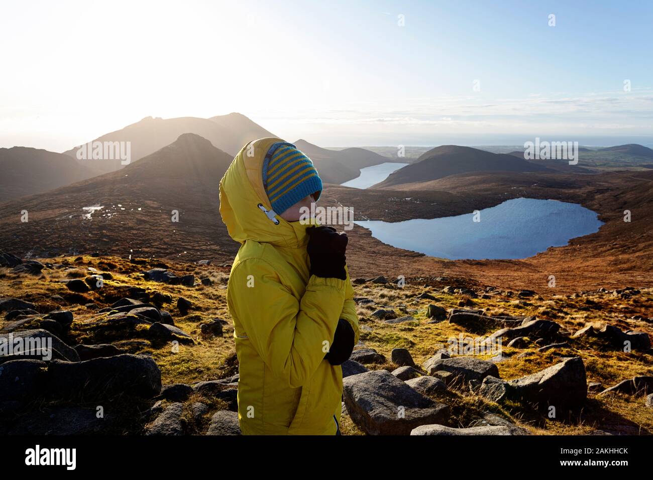 Mourne Mountains and lakes in Northern Ireland, UK. View from the of Slieve Loughshannagh, portrait of a young boy on the top of the mountain view Stock Photo
