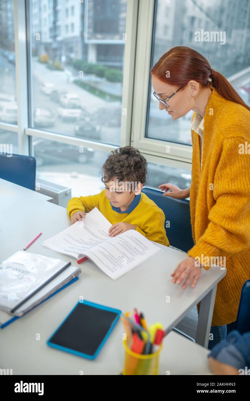Attentive teacher working with the schoolboy individually Stock Photo