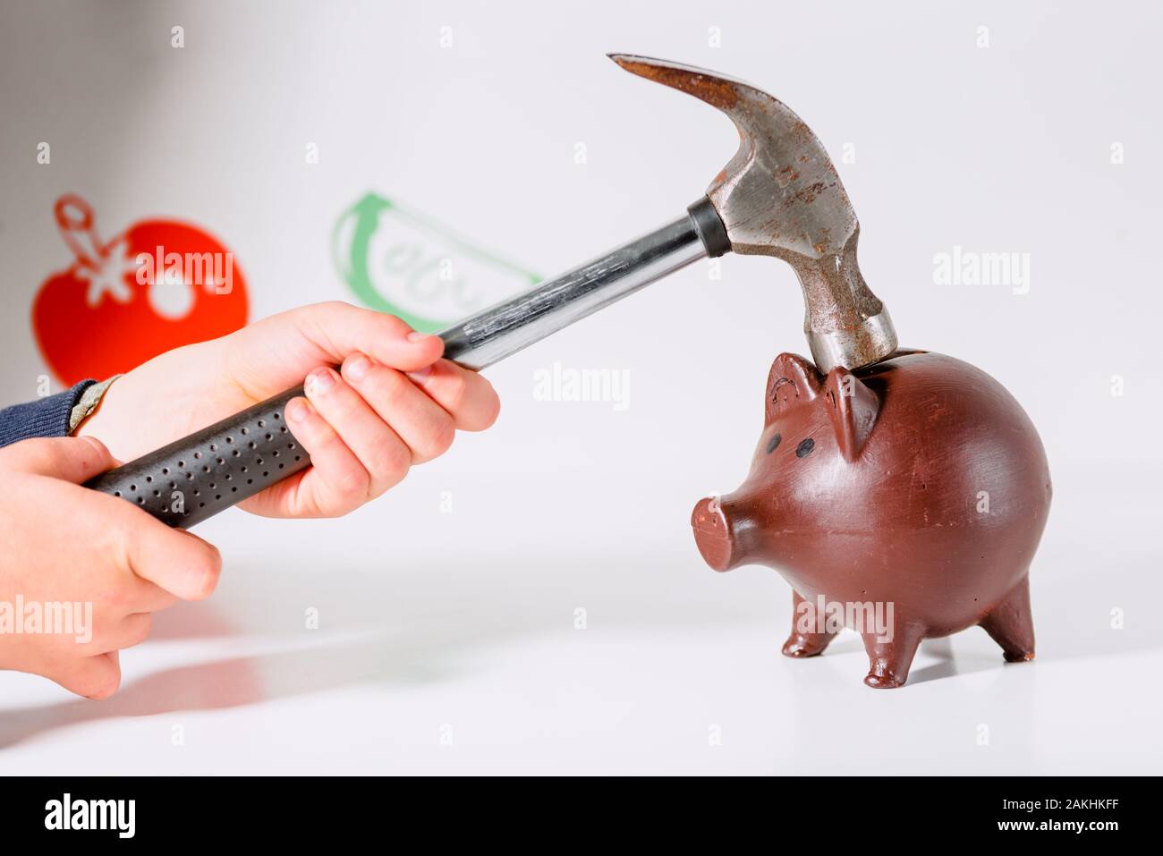 Woman hits a piggy bank with a hammer, isolated on white Stock Photo ...