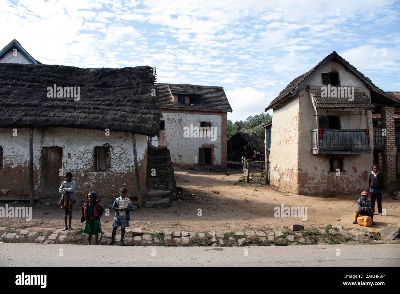 Malagasy people outside their houses in a Madagascar village Stock Photo