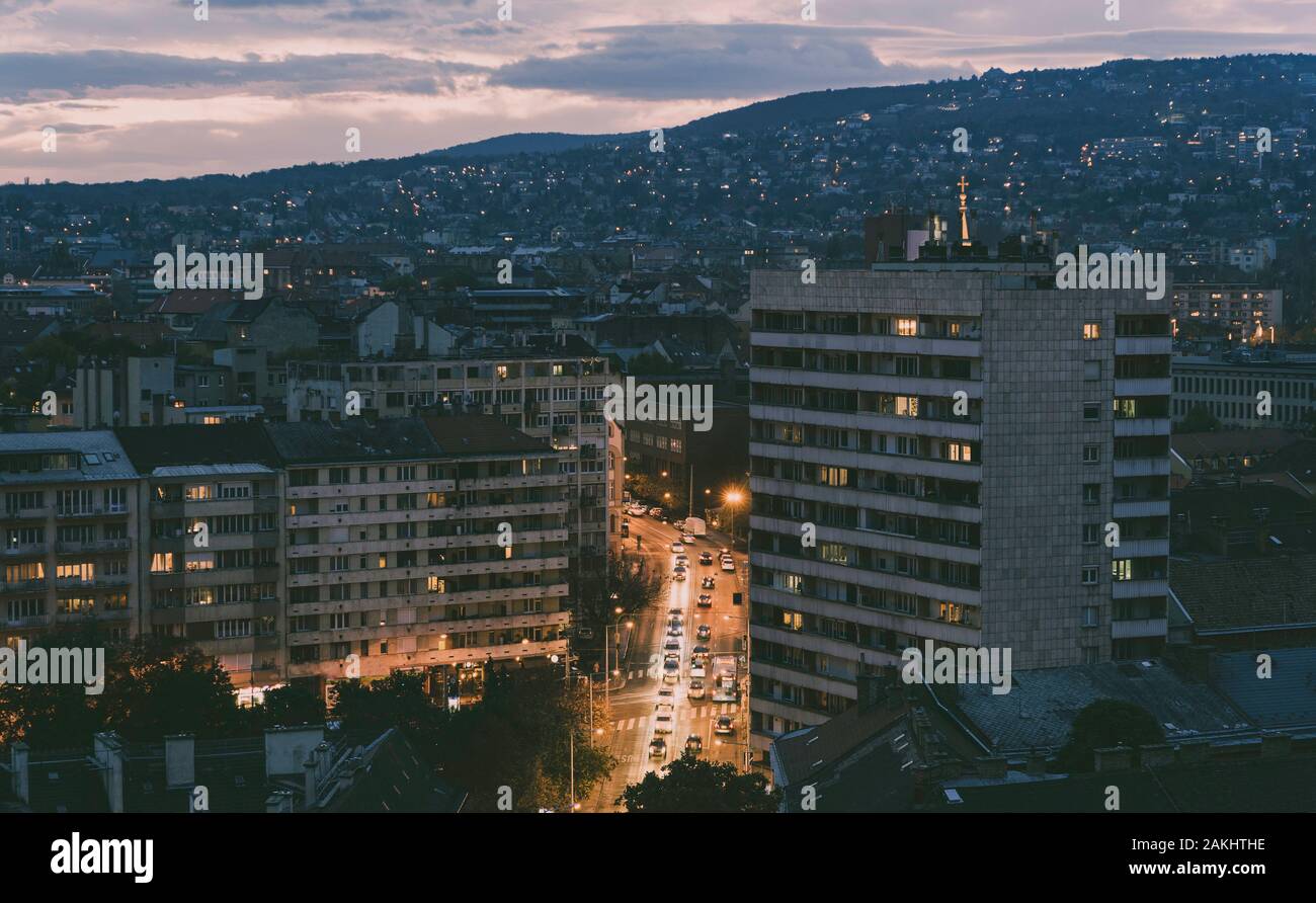 Buda hill at twilight. Beautiful street leading up to the hill between big concrete buildings. Budapest at sundown. Picture taken from above. Stock Photo