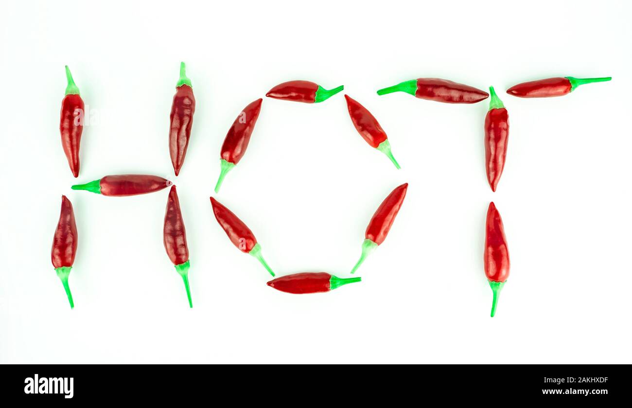 HOT word set out of red hot chili peppers. White background. Chili saltillo (Capsicum Annum) Stock Photo