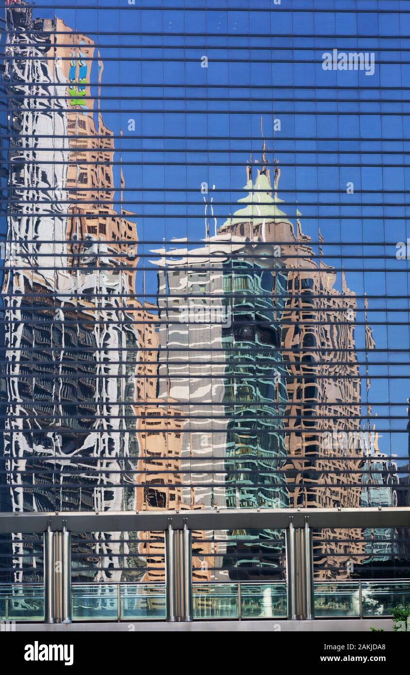 Building reflections in the glass windows of a modern skyscraper - example of modern city architecture, Hong Kong, Asia Stock Photo