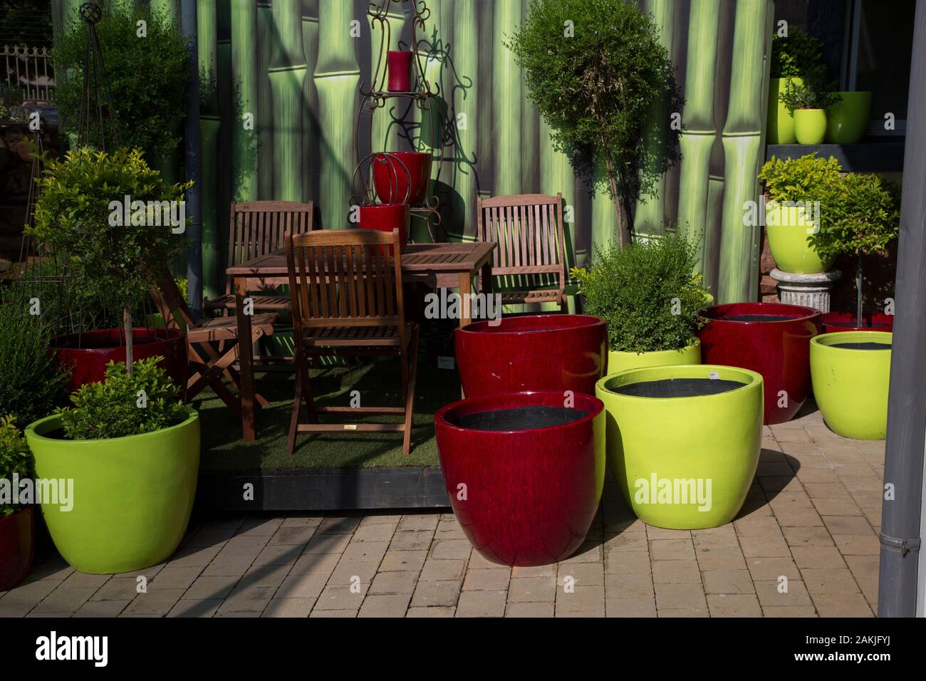 Colorful plant pots arranged in garden display Stock Photo