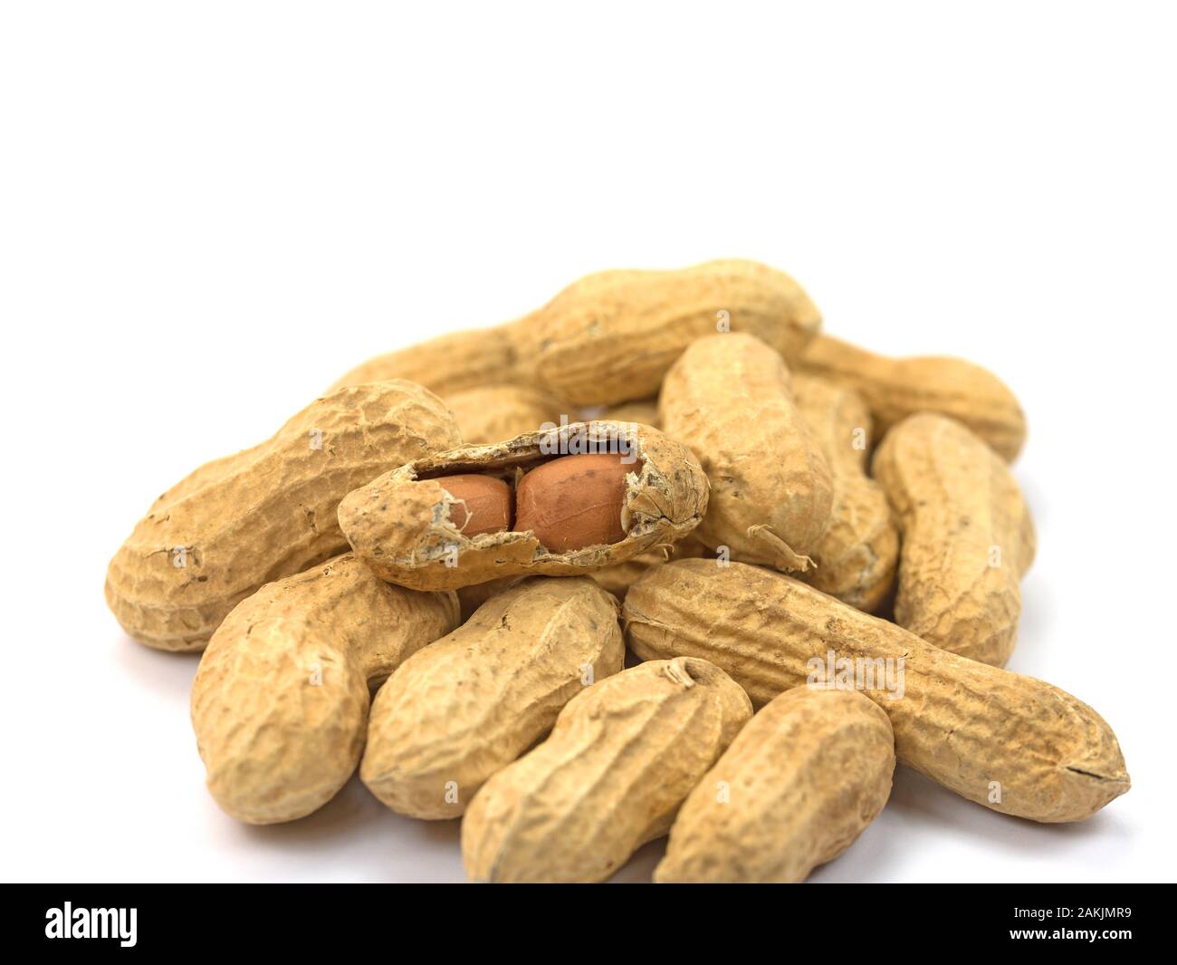 Roasted peanuts against a white background Stock Photo