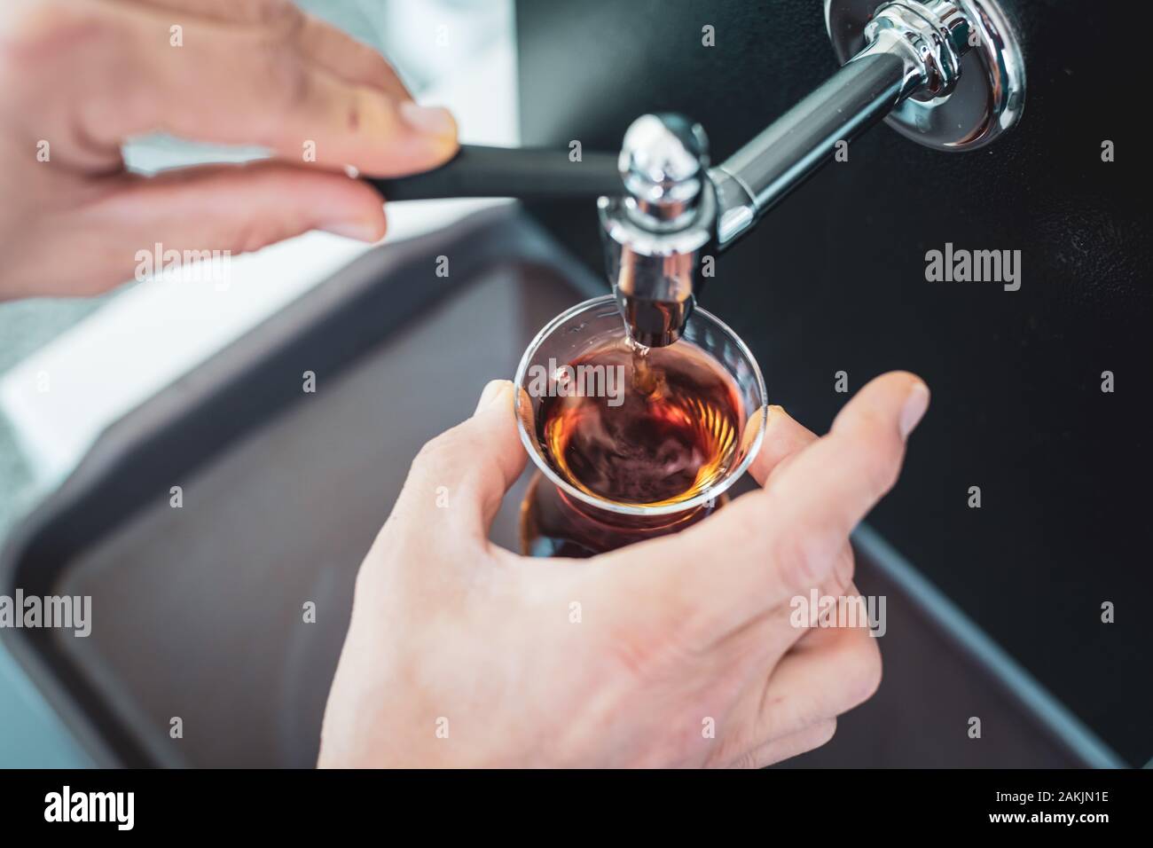 Caucasian man pouring traditional Turkish tea from teapot Stock Photo