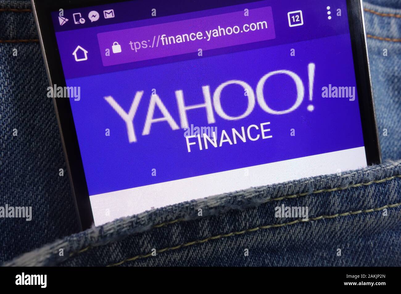 Yahoo Finance website displayed on smartphone hidden in jeans pocket