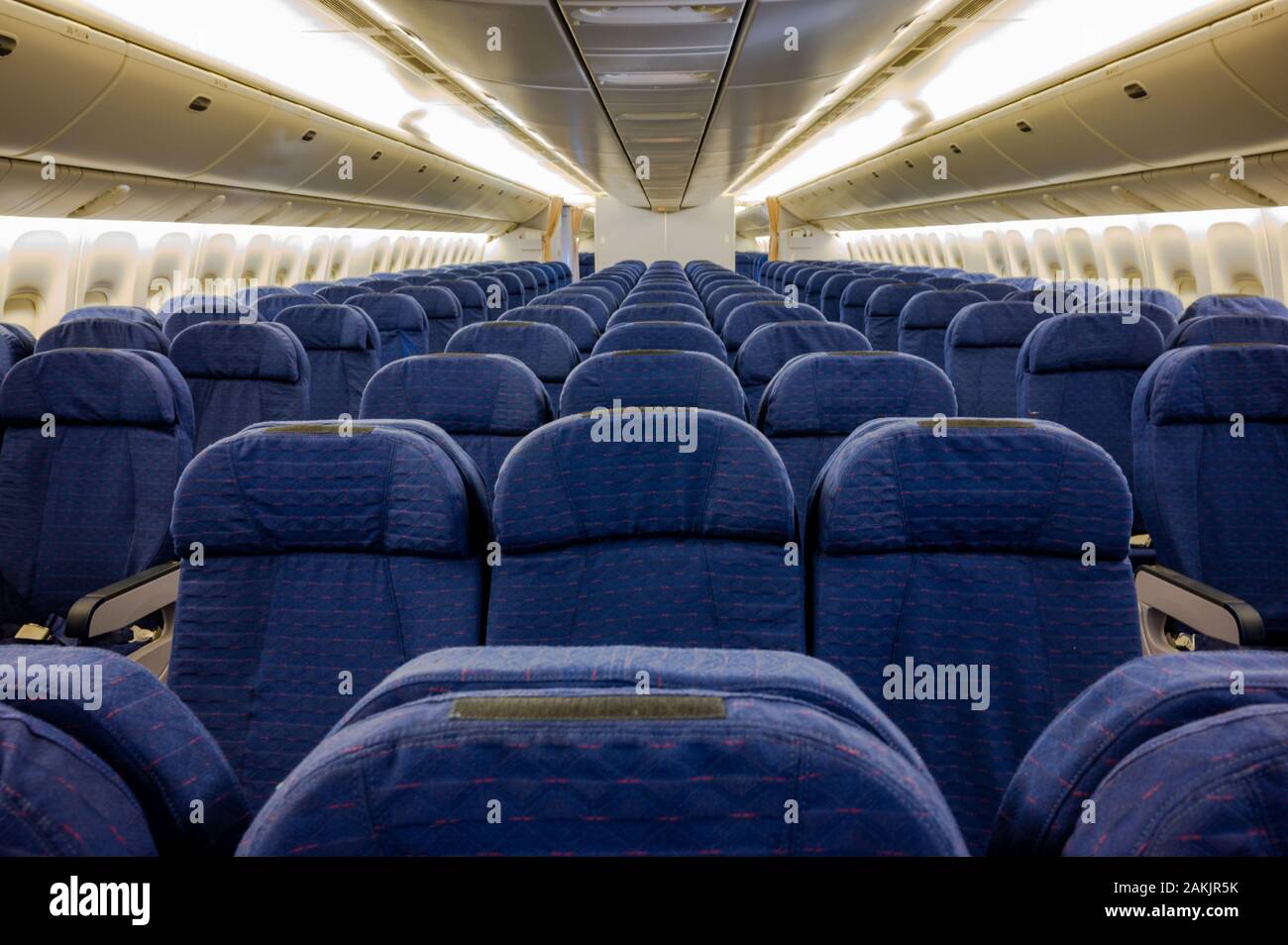 Large wide-body commercial aircraft coach class with no passengers and empty seats Stock Photo