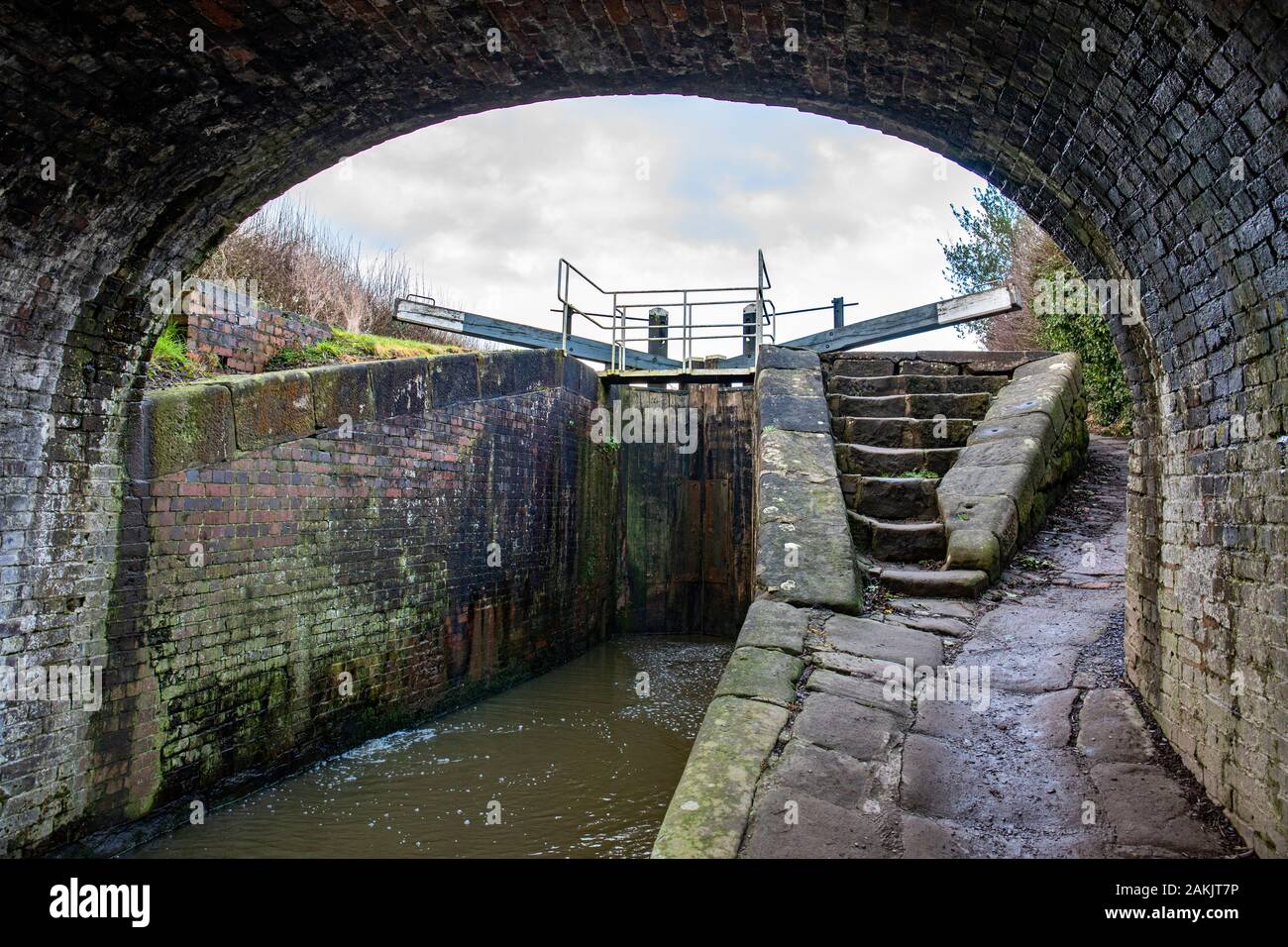 View under bridge No 27 towards lock on the Shropshire and Union Canal in Cheshire UK Stock Photo