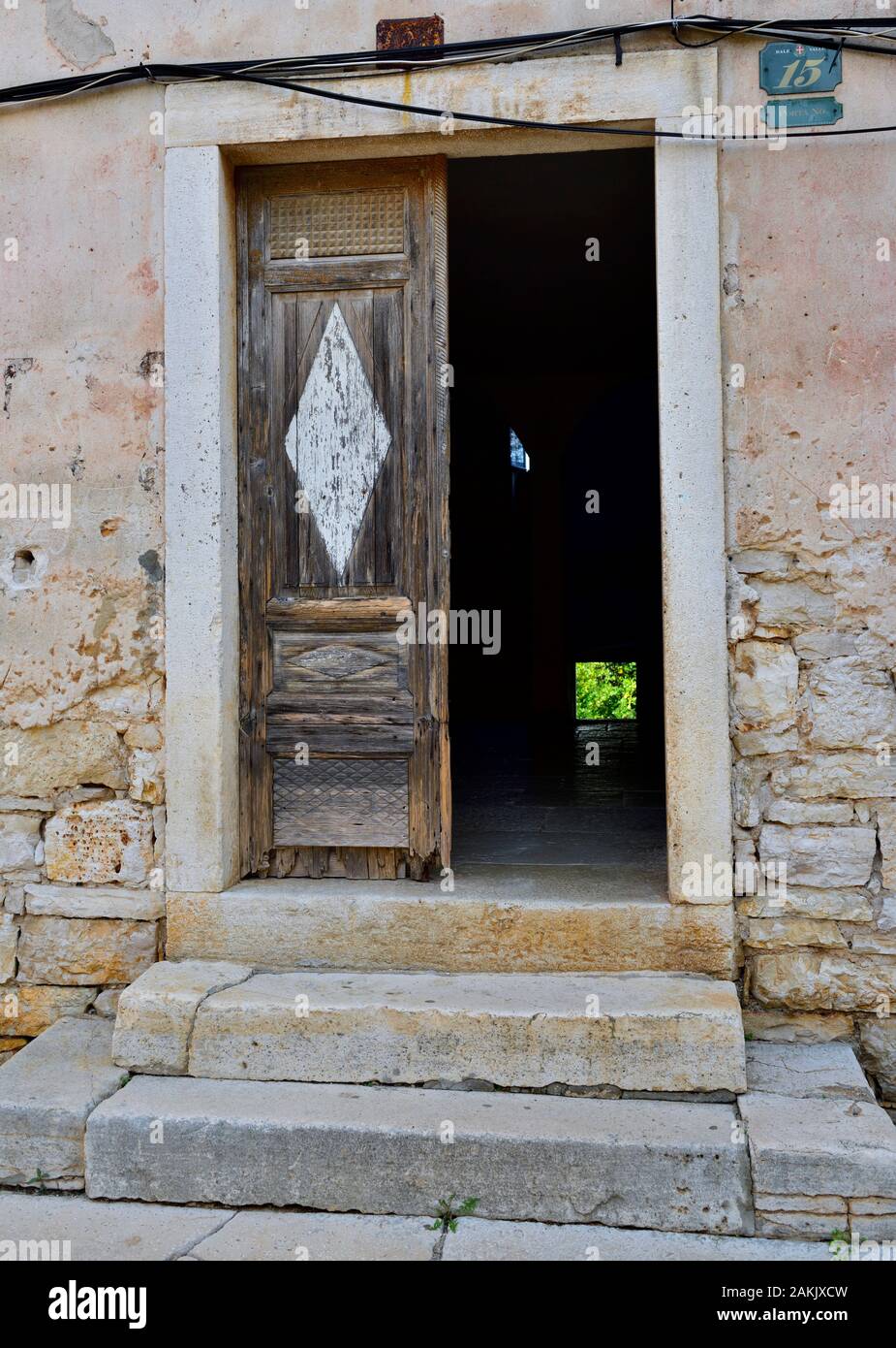 Looking Through Old Open Wooden Door To Darkness And Small Patch