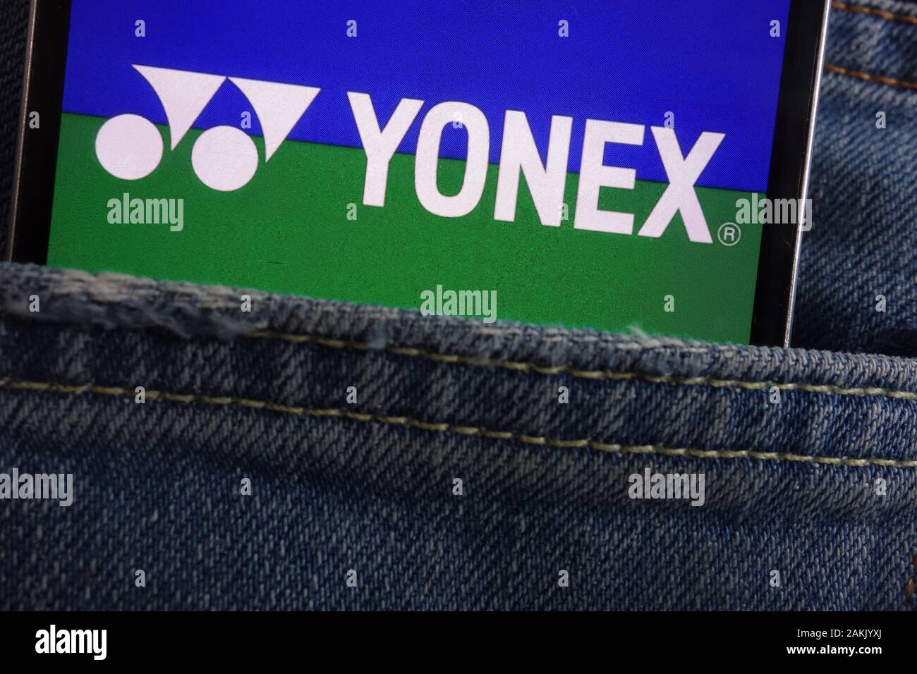 Yonex logo displayed on smartphone hidden in jeans pocket Stock Photo