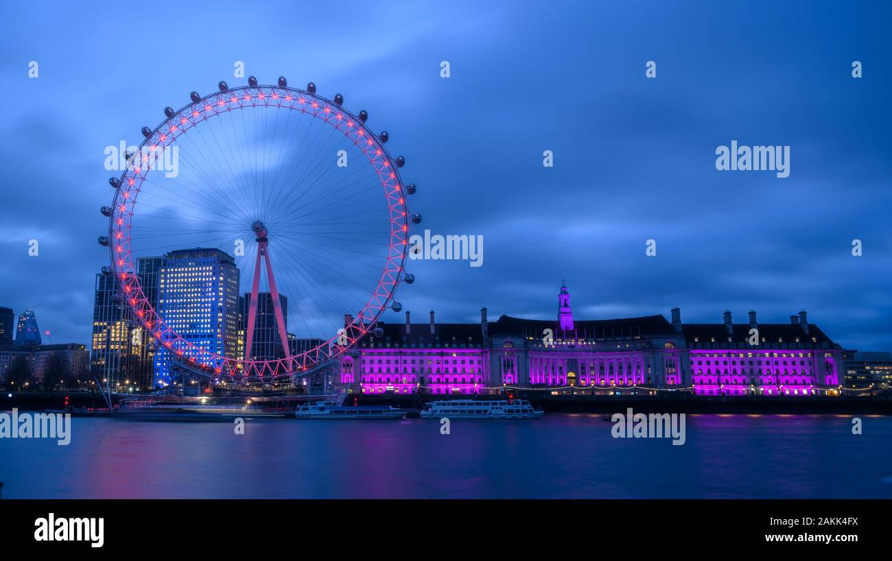 River Thames, London, UK. 9th January 2020. UK Weather: The lights of the  iconic London Eye and County Hall buildings along the South Bank bring brightness to an otherwise dull and gloomy morning in central London. Credit: Celia McMahon/Alamy Live News. Stock Photo