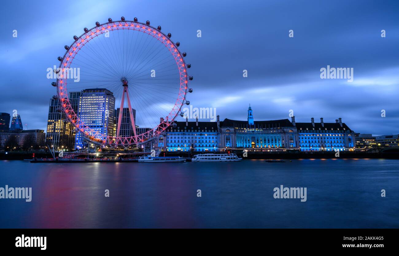 River Thames, London, UK. 9th January 2020. UK Weather: The lights of the  iconic London Eye and County Hall buildings along the South Bank bring brightness to an otherwise dull and gloomy morning in central London. Credit: Celia McMahon/Alamy Live News. Stock Photo