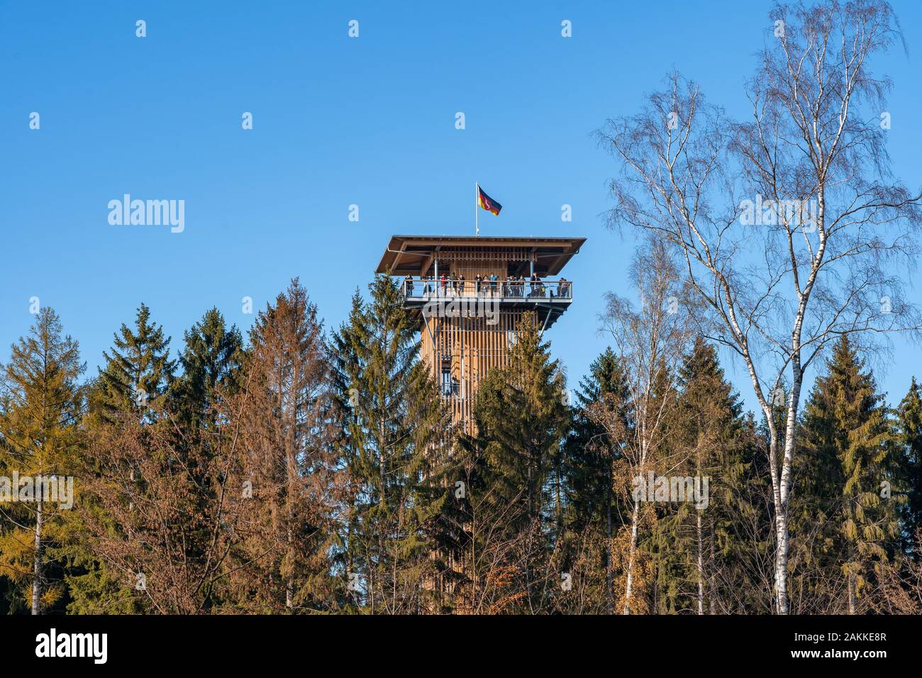 Luneberg, Germany - Nov 10, 2019: Tourists up on the overlook tower in Heide Wildlife Park with German flag on top Stock Photo
