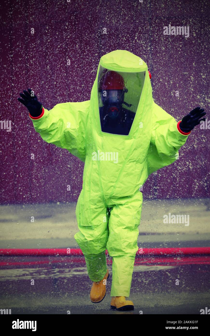 fireman wears a special protective suit to extinguish a fire caused by toxic substances Stock Photo