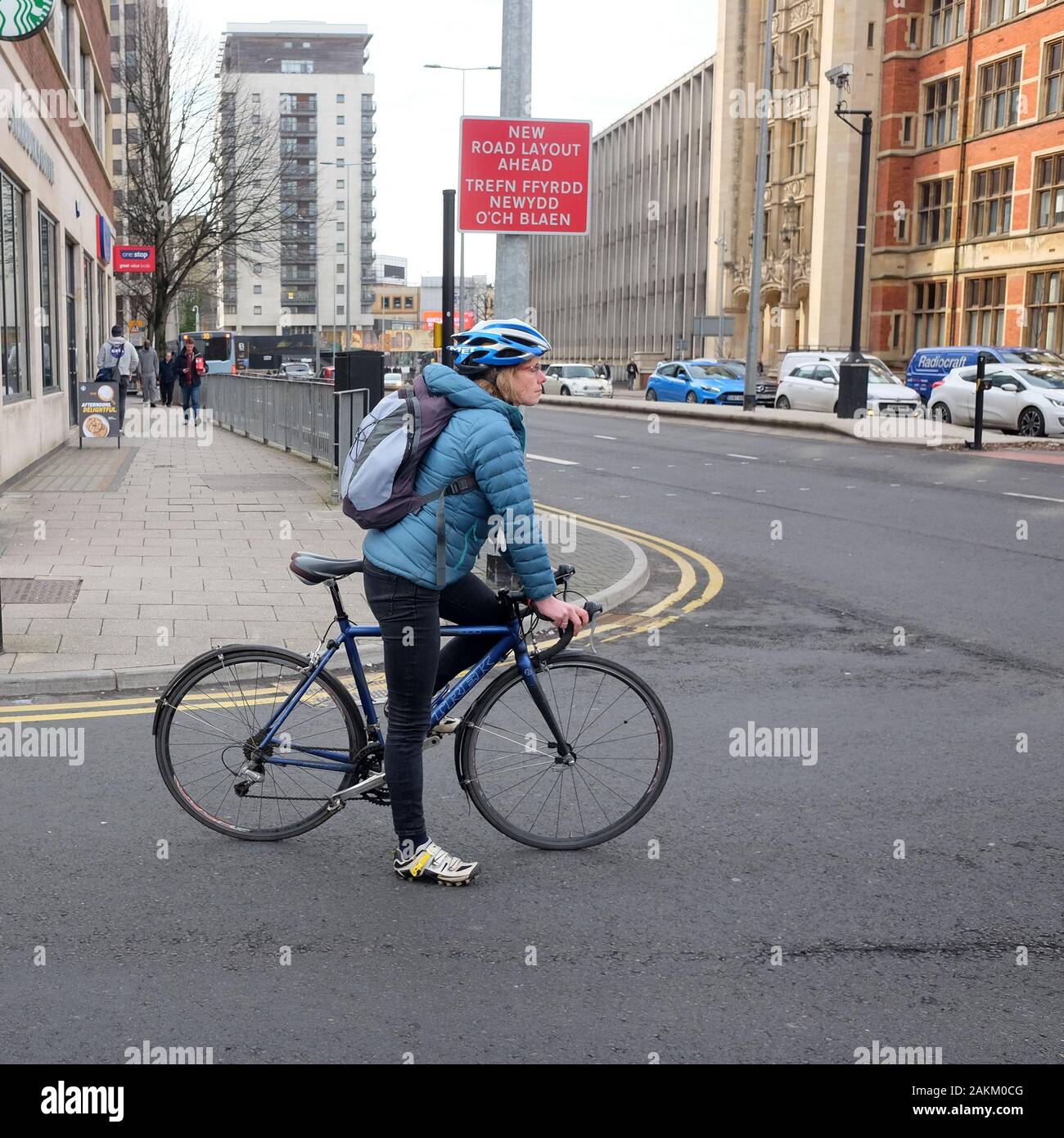 October 2019 - Cycle commuter on their bike at a traffic junction in Cardiff Stock Photo