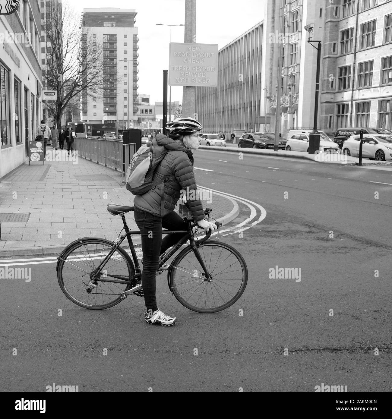October 2019 - Cycle commuter on their bike at a traffic junction in Cardiff Stock Photo
