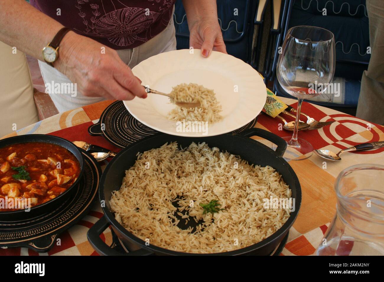 Serving the rice during a indian lunch outside Stock Photo - Alamy