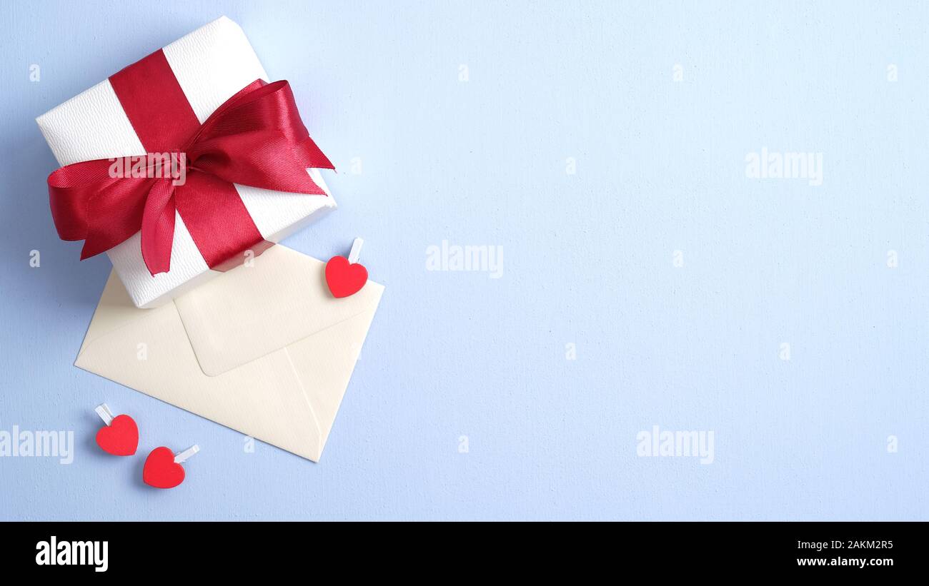 Download White Gift Box With Red Ribbon Bow And Envelope With Love Letter On Blue Background Valentines Or Mother Day Banner Design Flat Lay Top View Copy Stock Photo Alamy PSD Mockup Templates