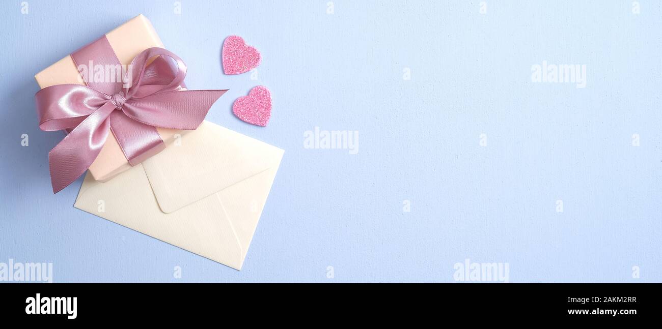 Valentine gift box with pink ribbon bow and envelope with love letter ...