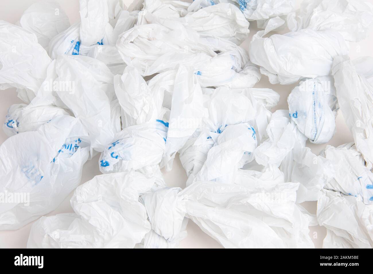 A closeup of a spread of white crumpled grocery labeled plastic bags