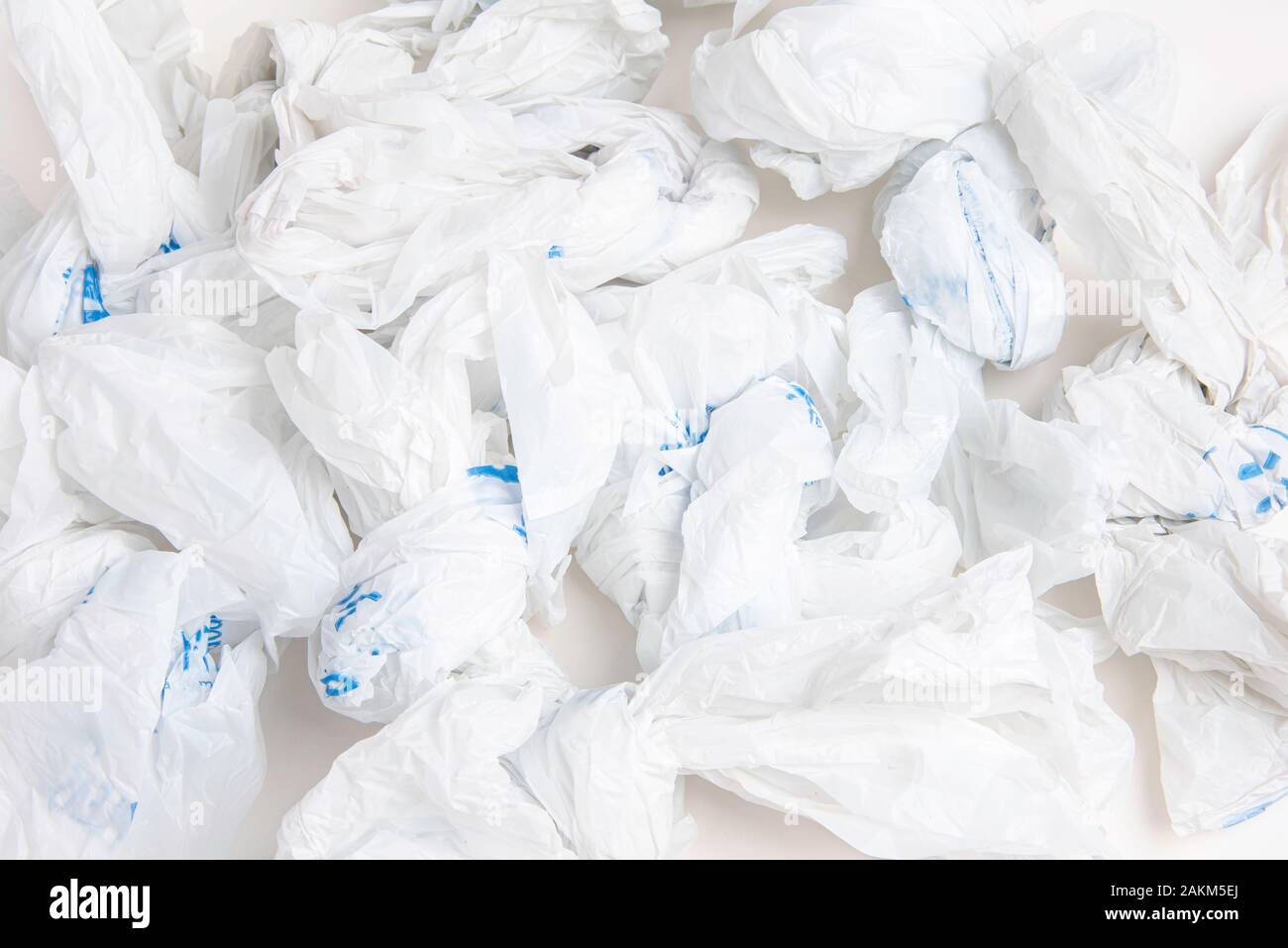 A closeup of a spread of white crumpled grocery labeled plastic bags