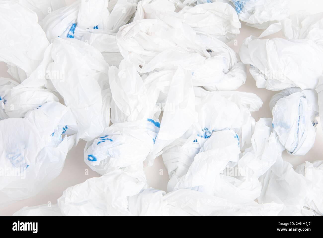 A closeup of a spread of white crumpled grocery labeled plastic bags