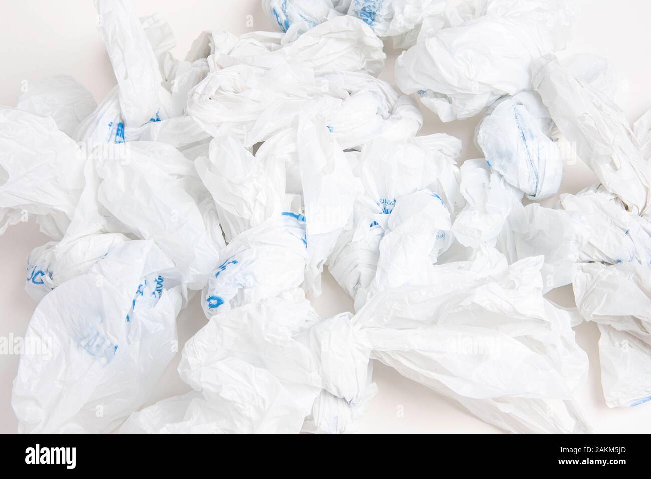 A closeup of a spread of white crumpled grocery labeled plastic bags