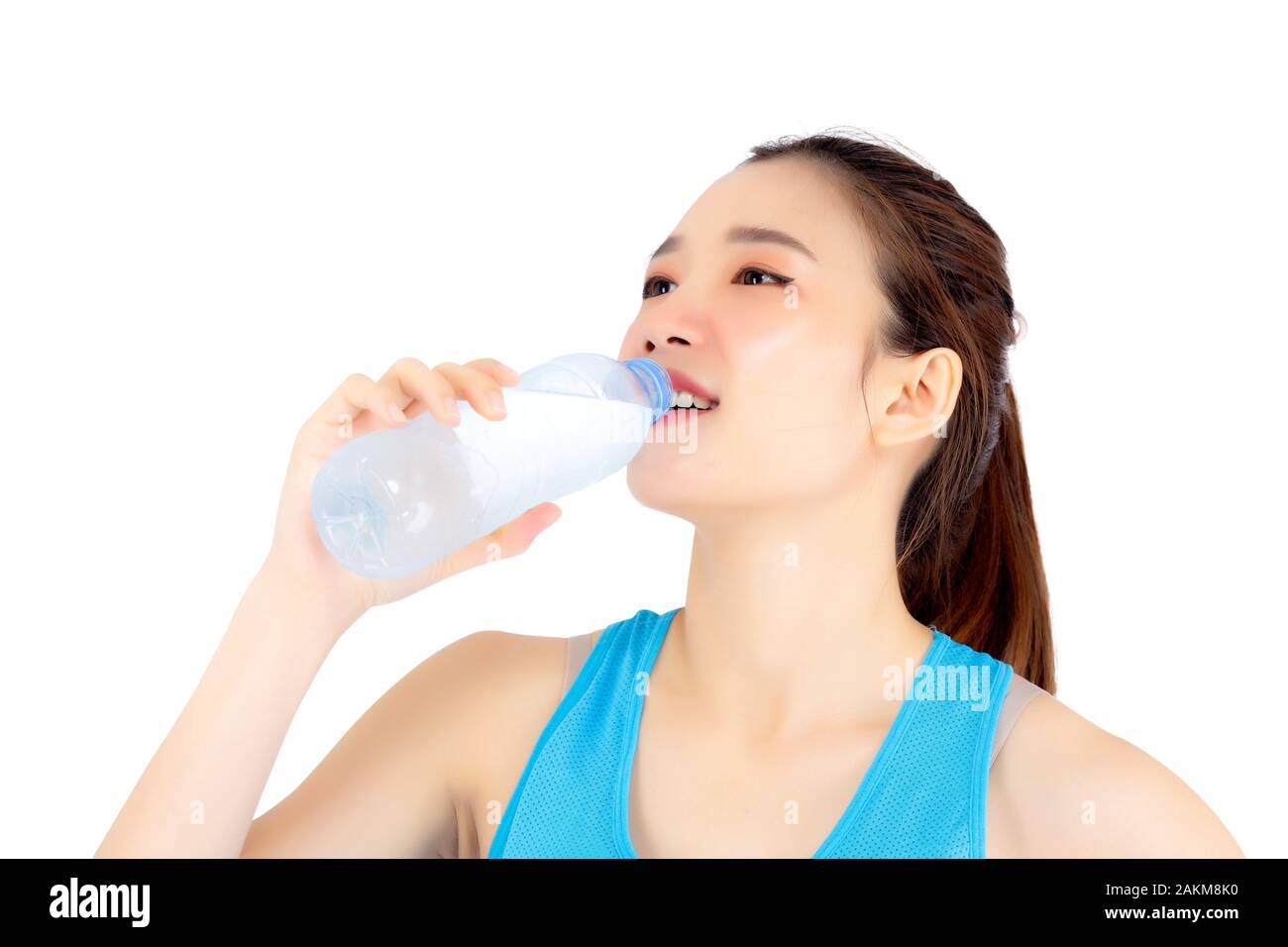 Beautiful portrait asian young woman in sport clothing drink bottle of water for healthy isolated on white background, girl with fit thirsty after exe Stock Photo