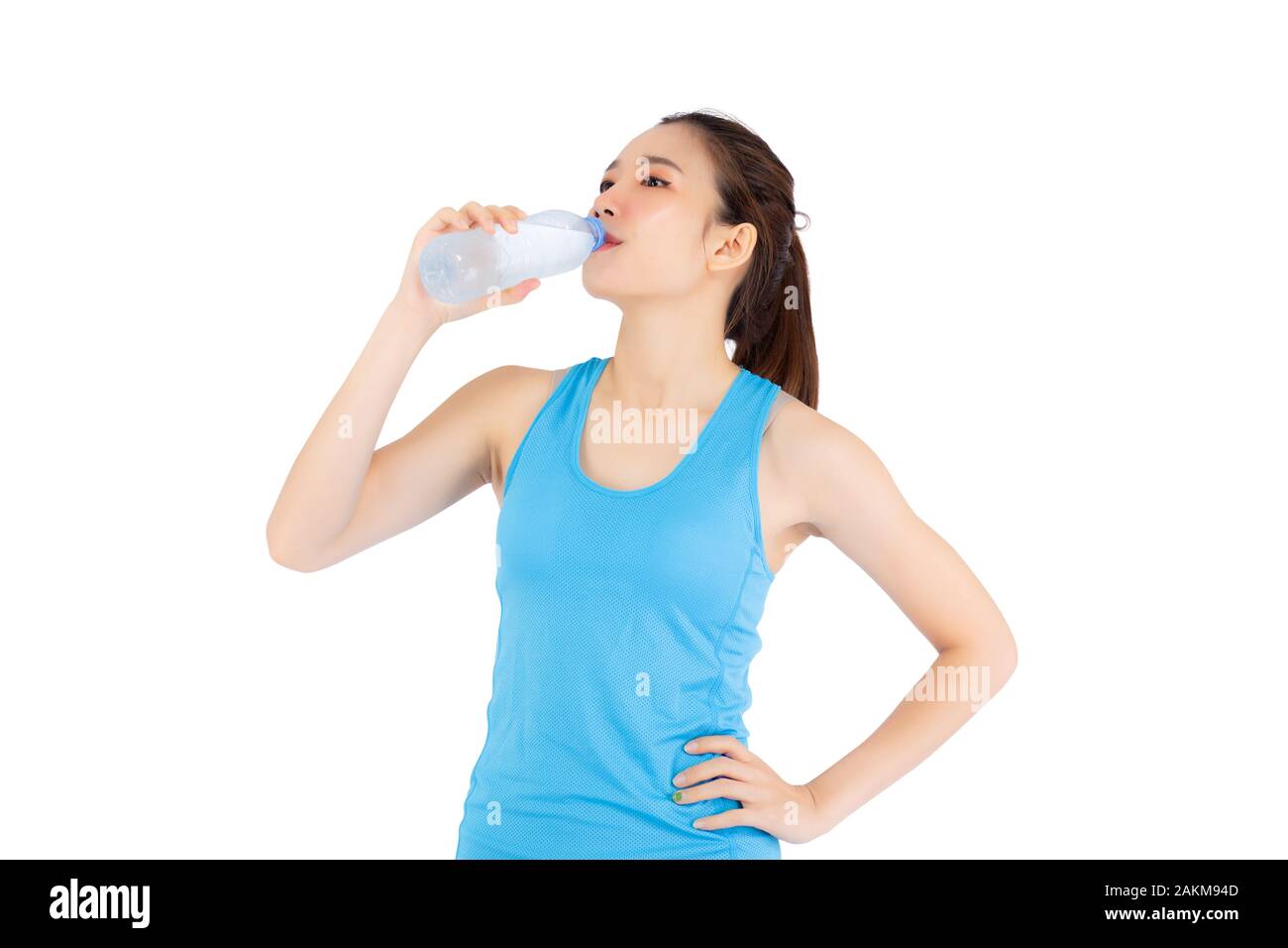 Beautiful portrait asian young woman in sport clothing drink bottle of water for healthy isolated on white background, girl with fit thirsty after exe Stock Photo