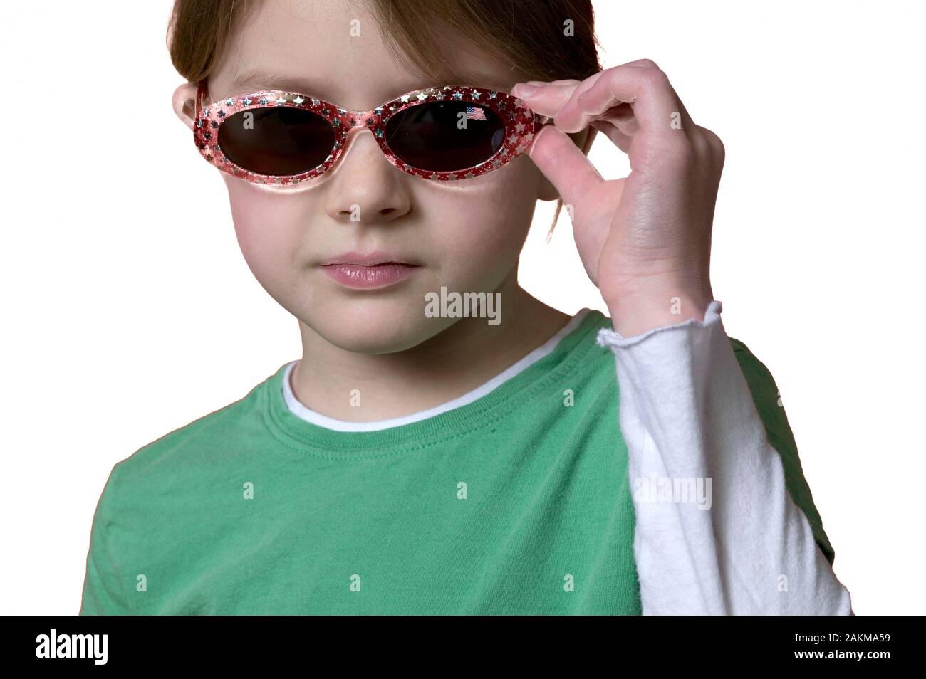 Cool little 10yearold girl wearing sunglasses, portrait on a white