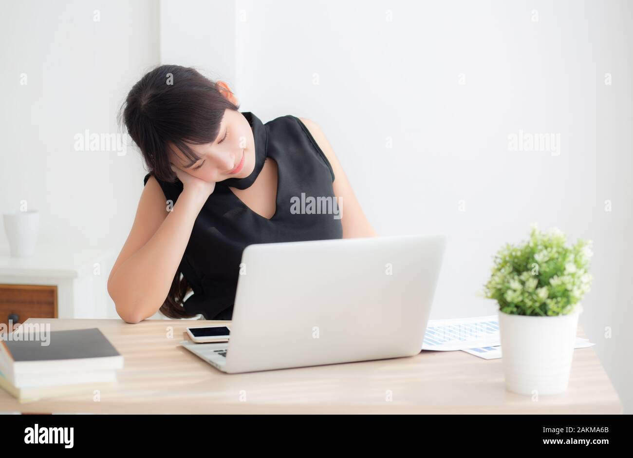Business woman overwork on laptop computer and neck pain with at work in office, girl stress and illness chronic with office syndrome, health and emot Stock Photo
