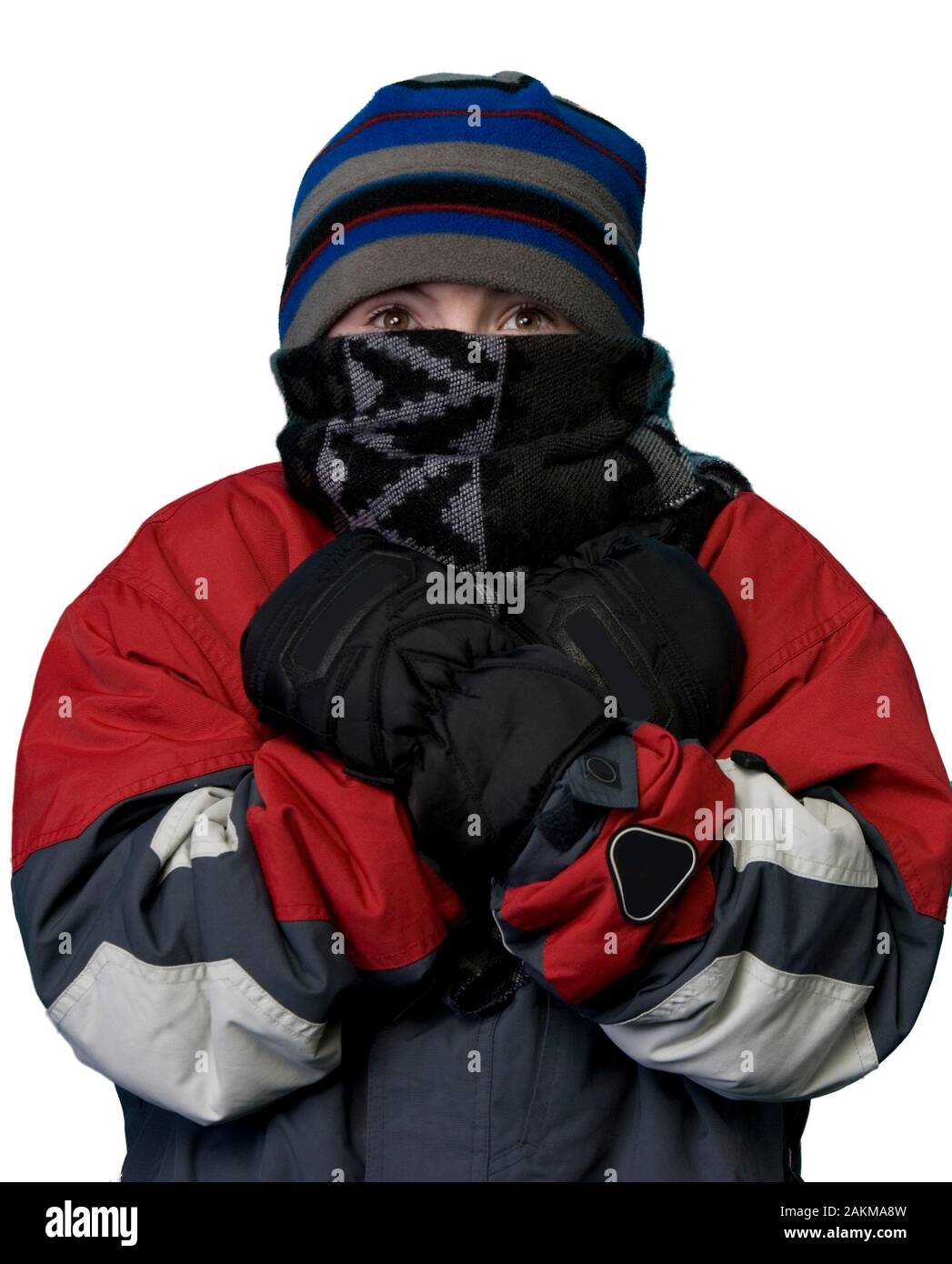 Young boy bundled up in winter clothing portrait on a white background Stock Photo