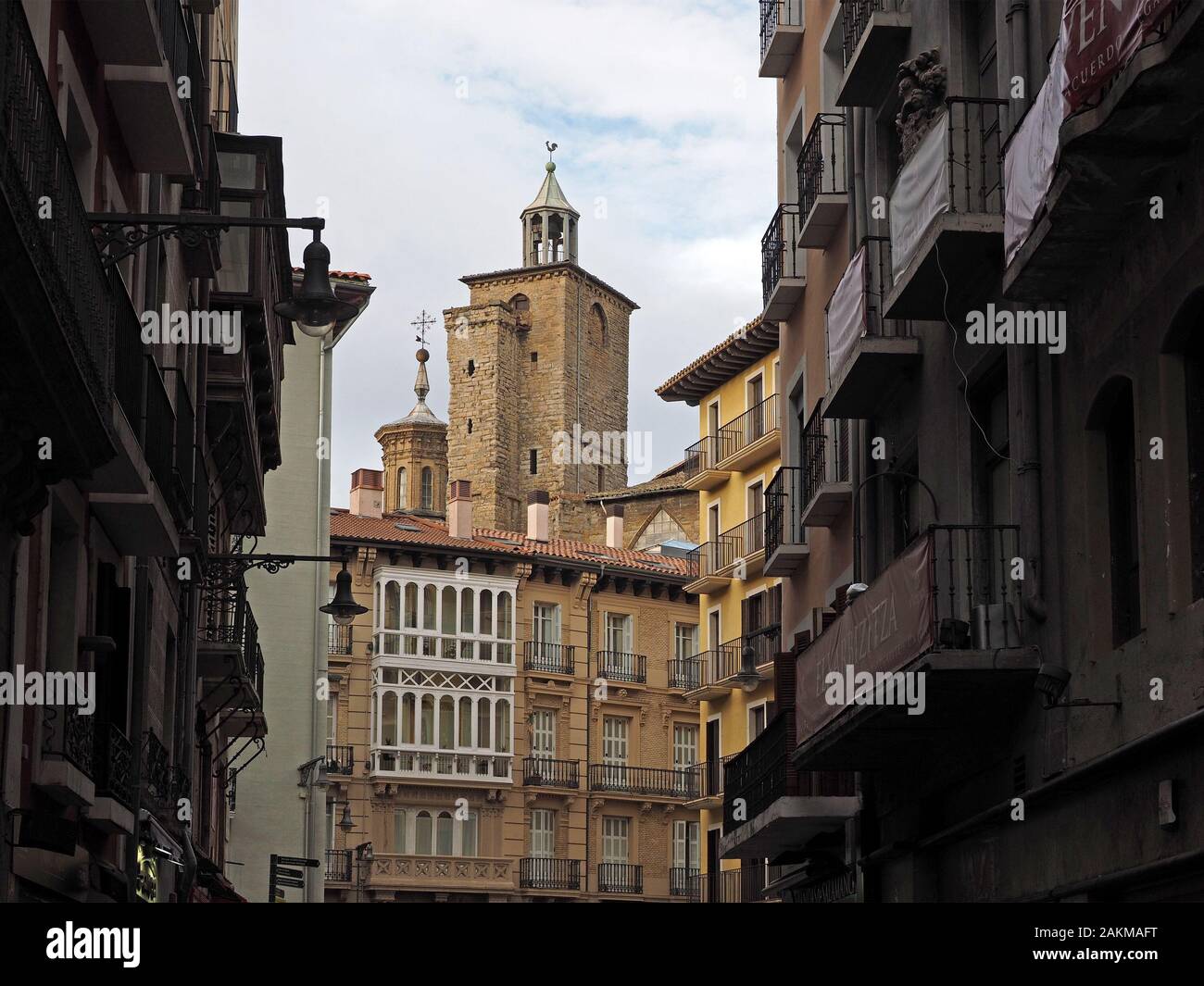 view of the towers of gothic San Saturnino church (Iglesia San Cernin) originally a defensive fortress seen from the streets of Pamplona, Spain Stock Photo