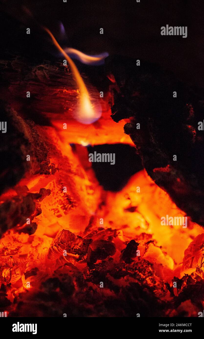 Close up of Burning Woods and Embers inside of a Fireplace. Stock Photo