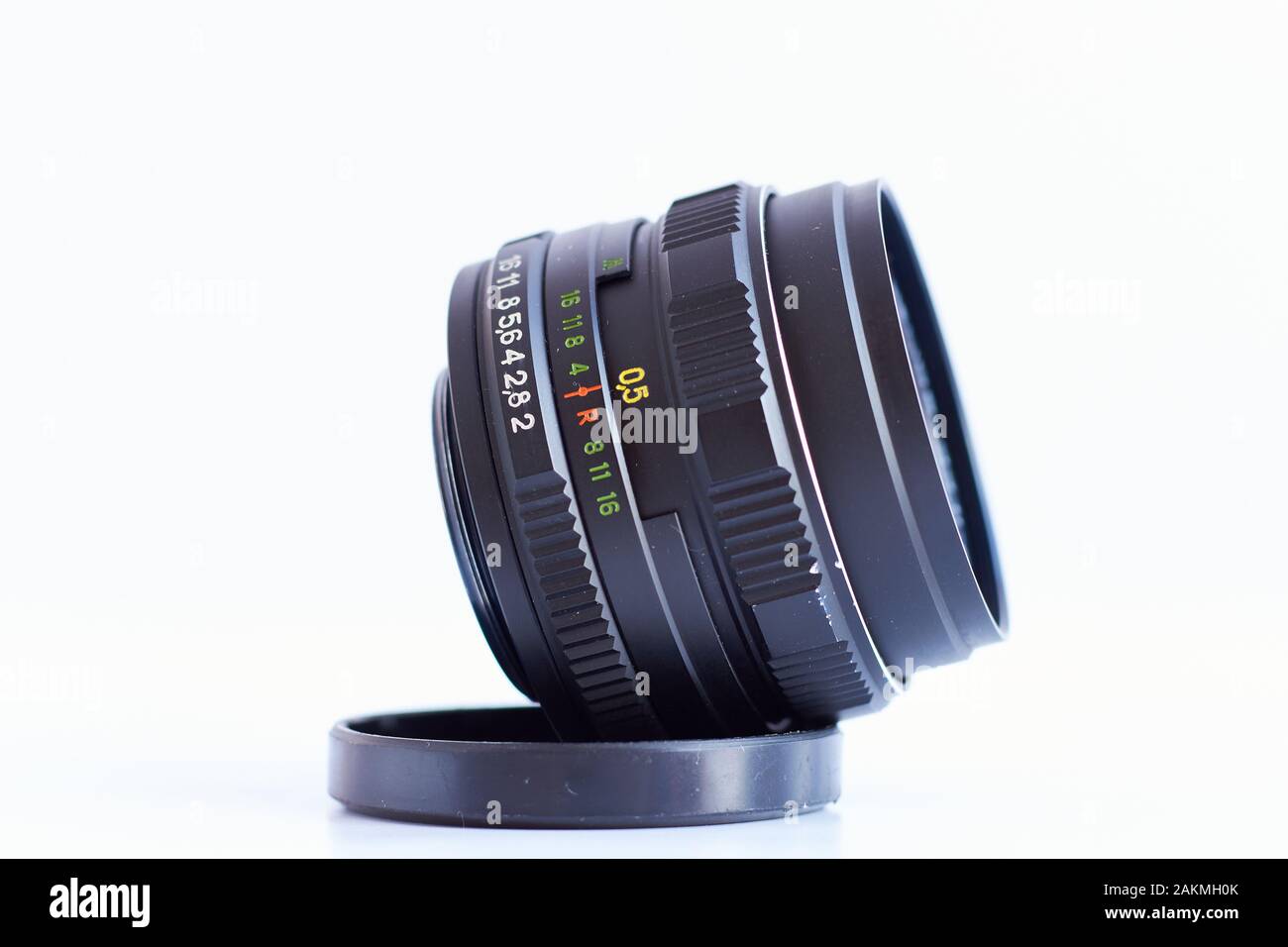 Old Russian Zenith vintage 58mm fixed lens isolated with white background, focus on aperture ring. Stock Photo