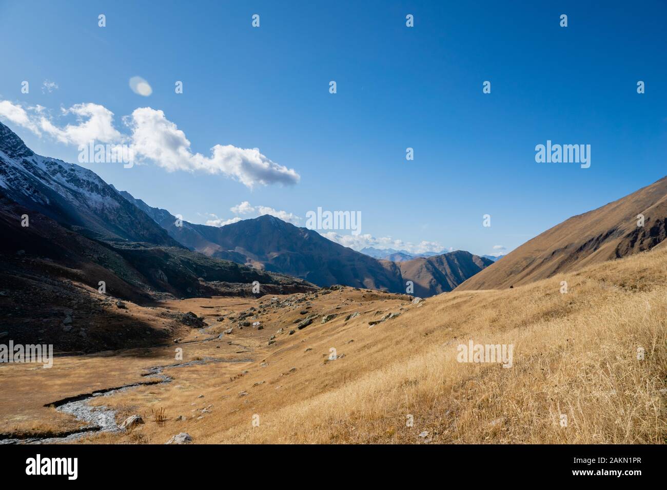 Juta trekking path landscape with river and mountains in sunny autumn day - popular trekking in the Caucasus mountains, Kazbegi region, Georgia. Stock Photo