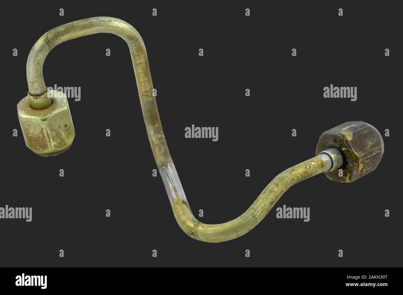A steel fuel injector line for a diesel engine isolated on dark background that had to be