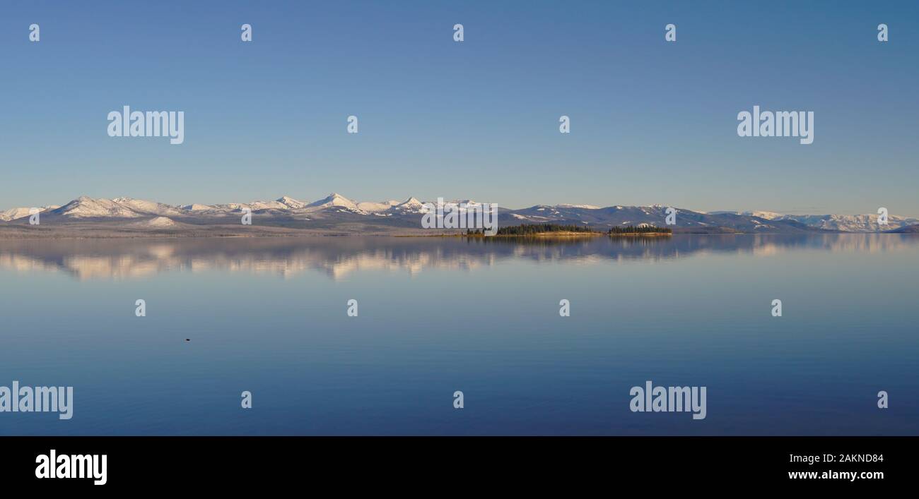 Panoramic shot of Yellowstone Lake and the snow covered Absaroka Mountain Range in the distance. Stock Photo