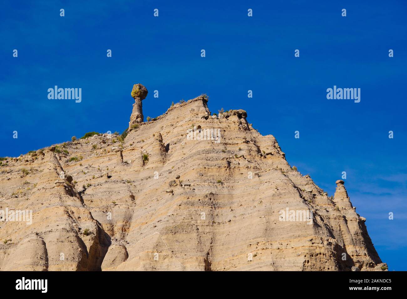 Erosion has created a very large and unusual pinnacle on top of a sandstone mountain in Tent Rocks. Stock Photo