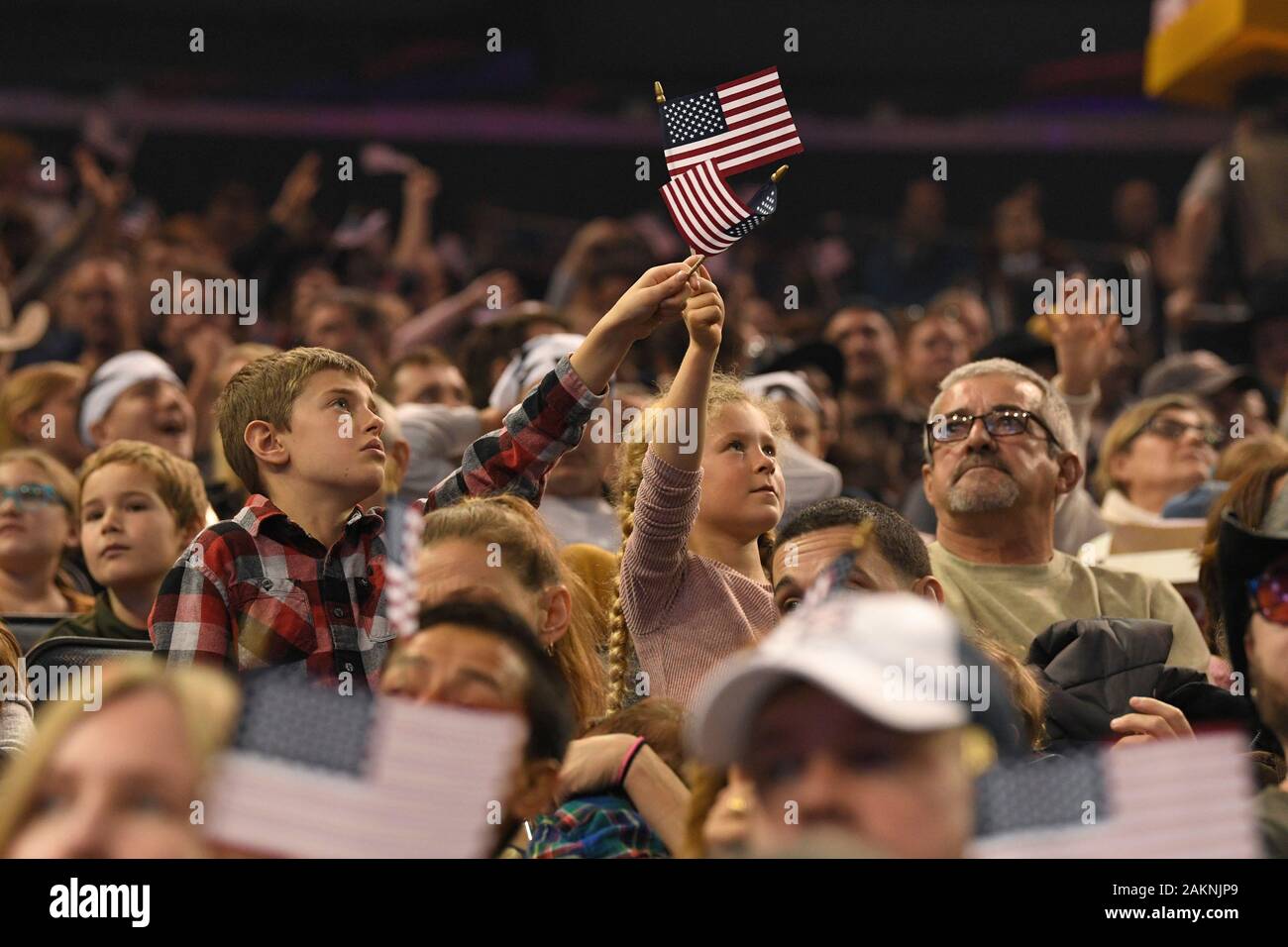 Spectators Hold Us Flags During The Professional Bull Riders 2020