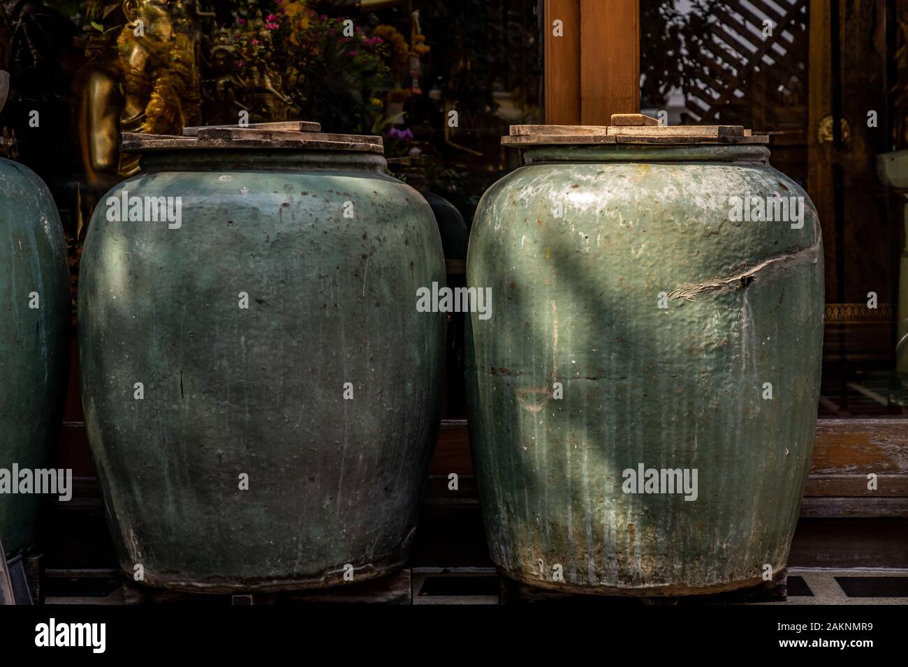 Row of old big earthen jars and rough green floor, Two Beautiful brown