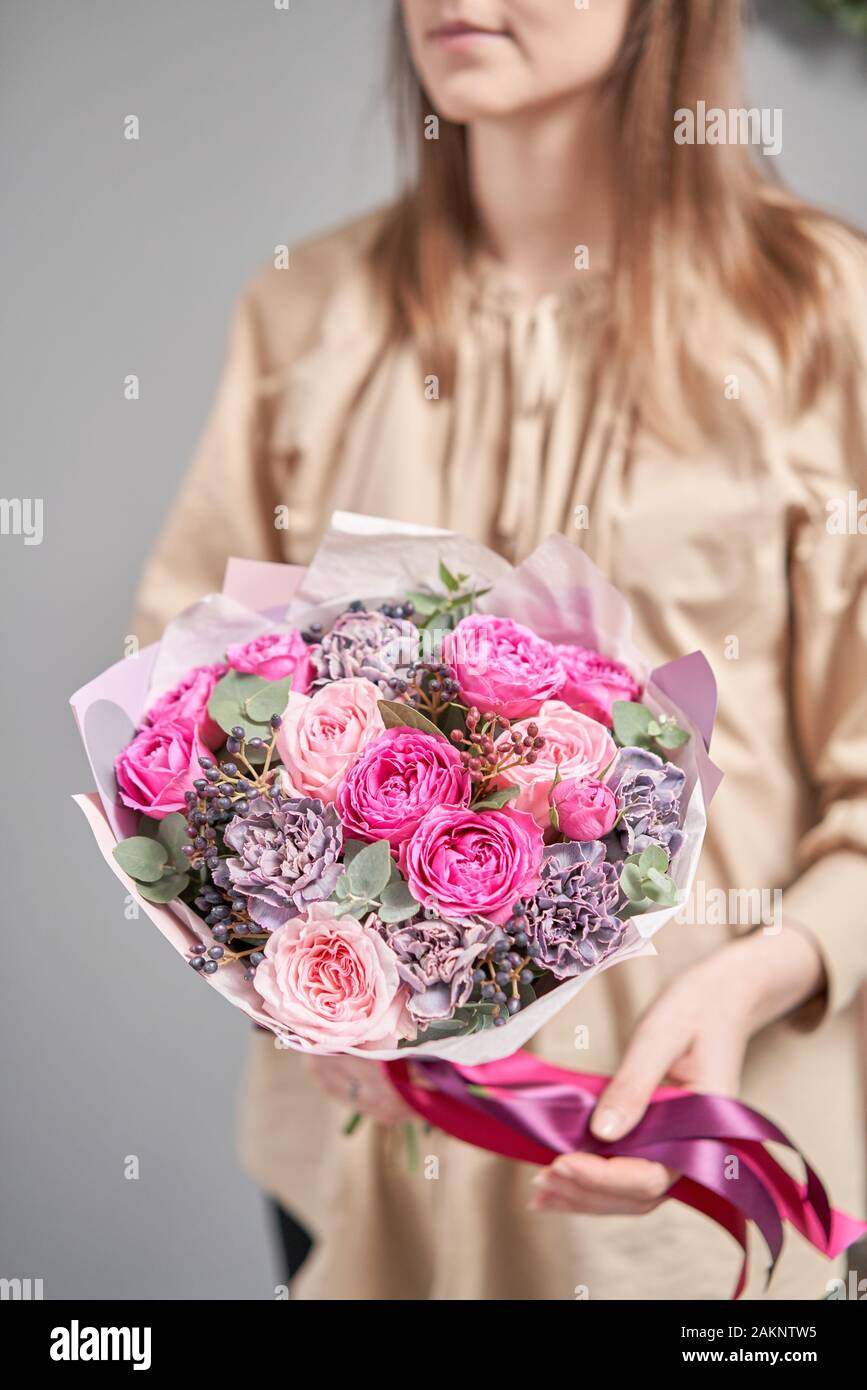 European floral shop. Beautiful bouquet of mixed flowers in womans
