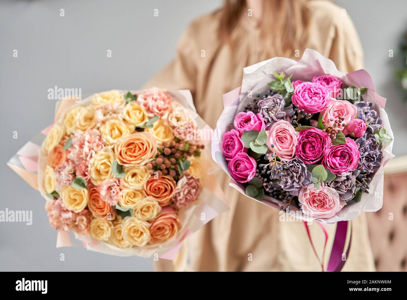 European floral shop. Two Beautiful bouquets of mixed flowers in womans