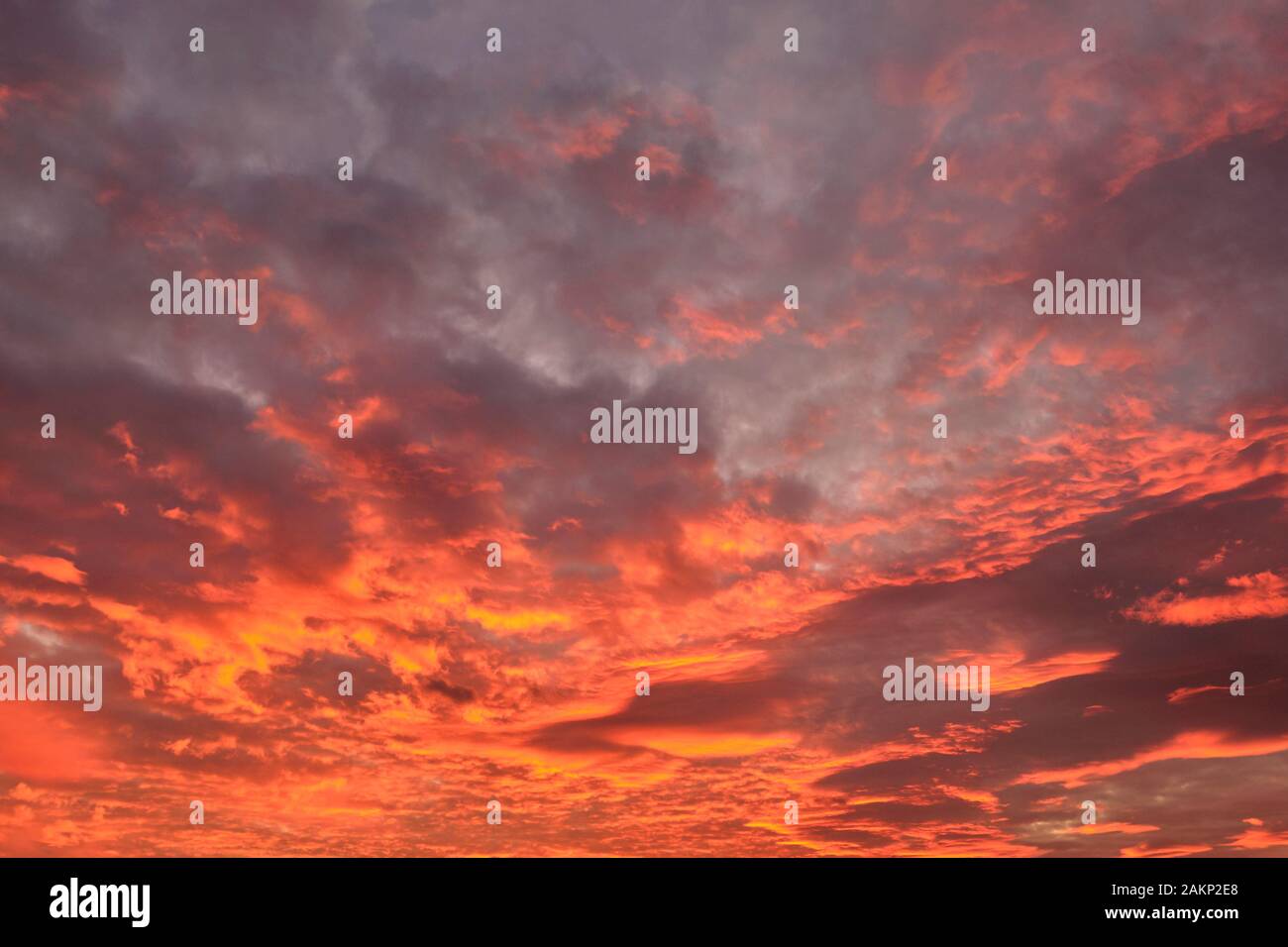 dramatic cloudy sky in the rays of setting sun. Stock Photo