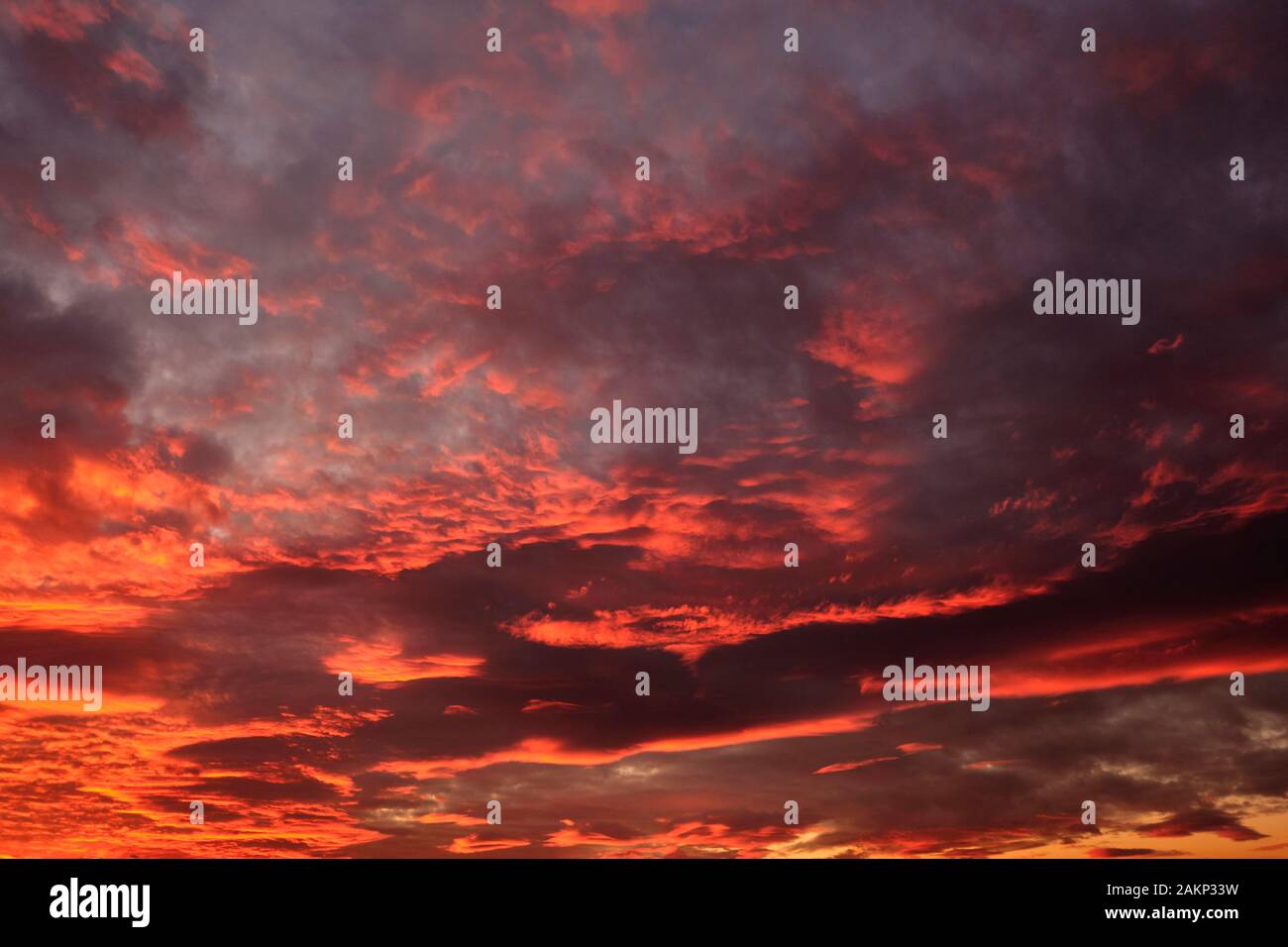 dramatic cloudy sky in the rays of setting sun. Stock Photo