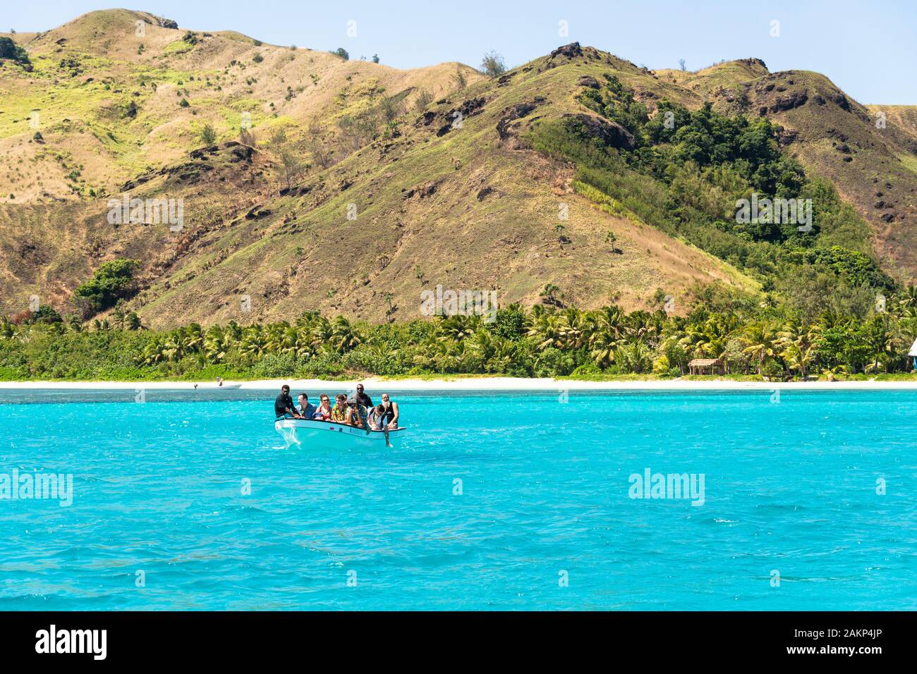 Yasawa, Fiji - September 24 2019: A boat carry tourists to another one leaving an idyllic island in Fiji in the south Pacific ocean Stock Photo