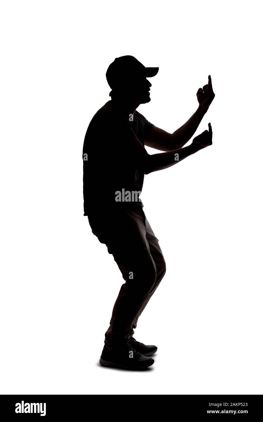 Silhouette of a man wearing casual clothes isolated on a white background. He is being rude and angry Stock Photo